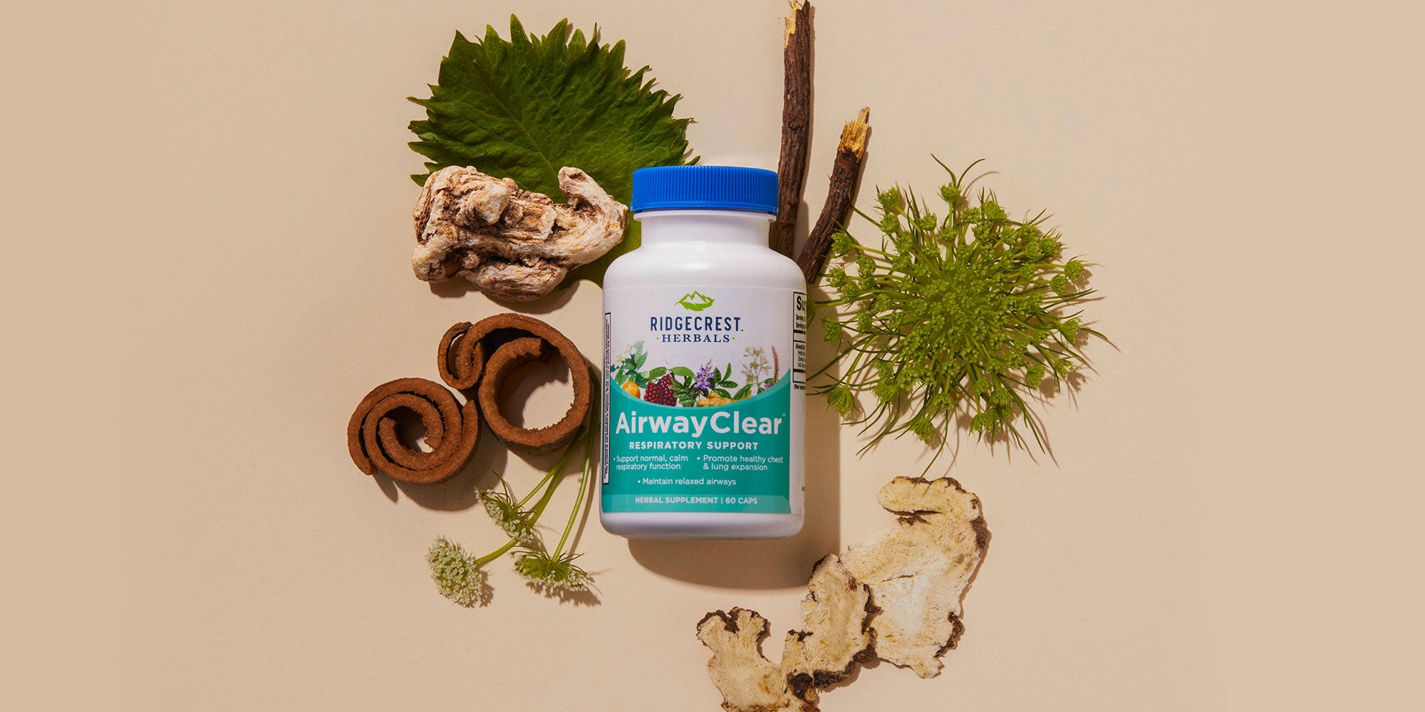 AirwayClear supplement is displayed with dried herbs, cinnamon bark, and green leaves, set against a beige background.