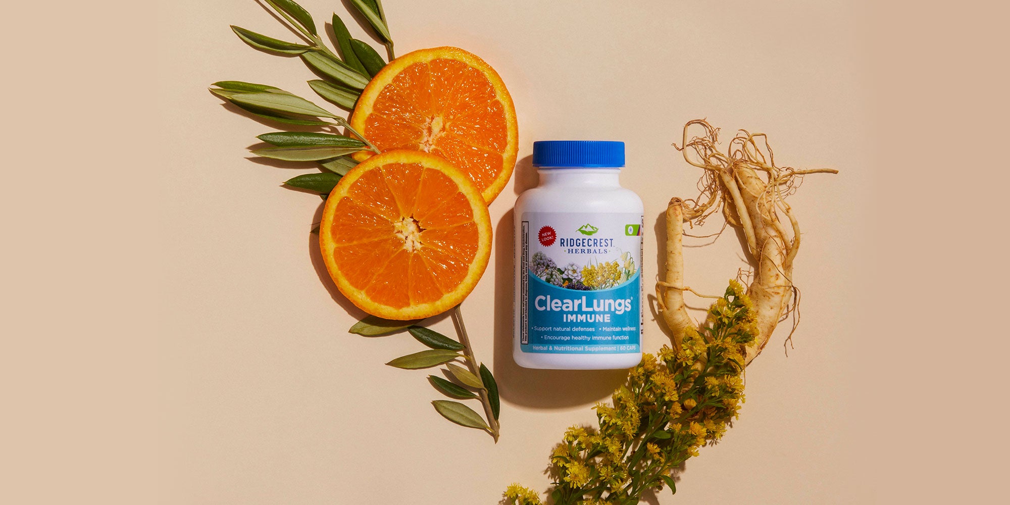 ClearLungs Immune supplement is displayed with sliced oranges, ginseng roots, and yellow flowers, set against a beige background.