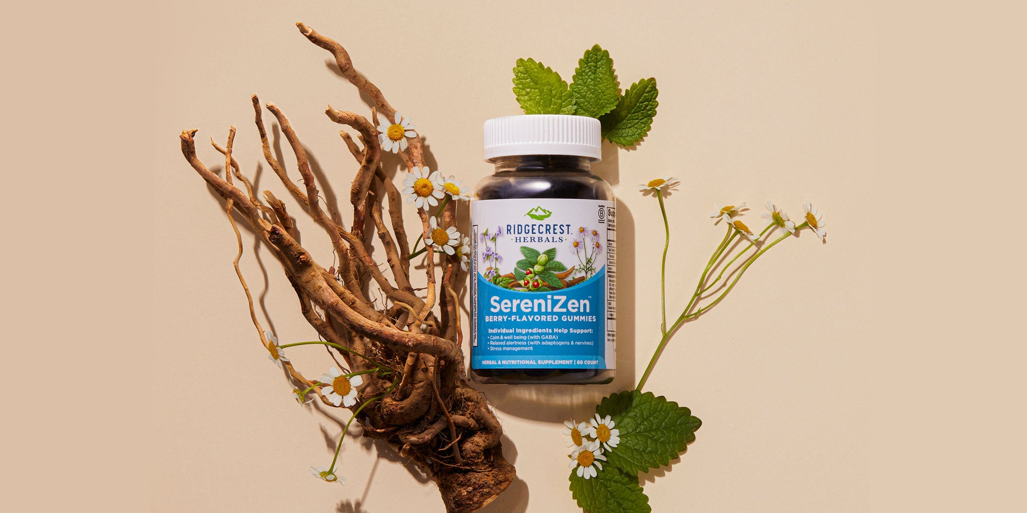 SereniZen Berry-Flavored Gummies alongside chamomile flowers, roots, and green leaves on a beige background