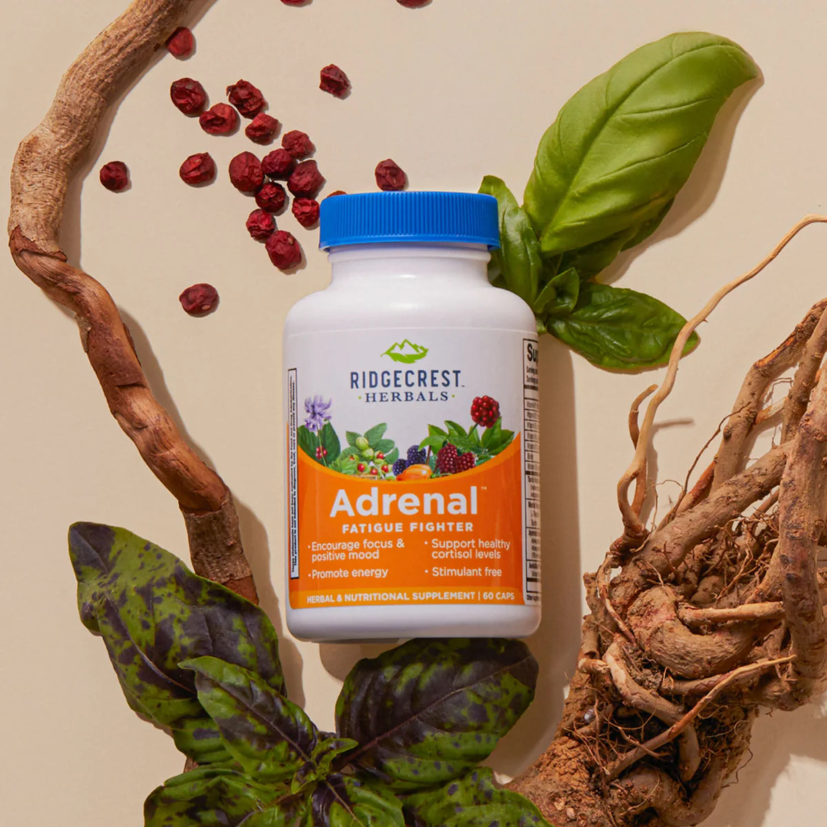 A square product photograph of a "RidgeCrest Herbals AdrenaLove" bottle surrounded by red berries (Schisandra), dried roots, and fresh basil leaves on a beige background.