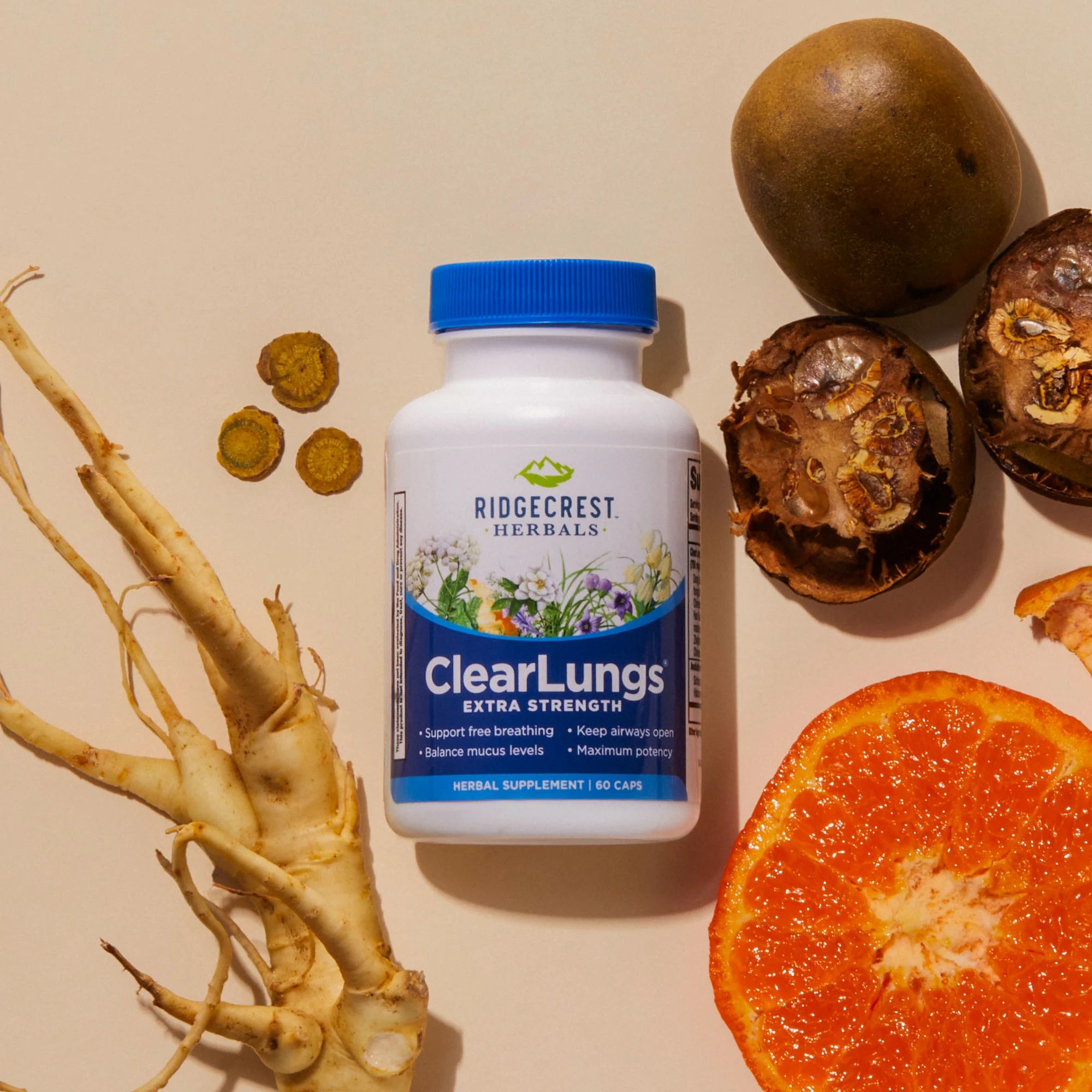 ClearLungs Extra Strength supplement is displayed alongside a sliced orange, dried herbs, roots, and natural ingredients on beige background.