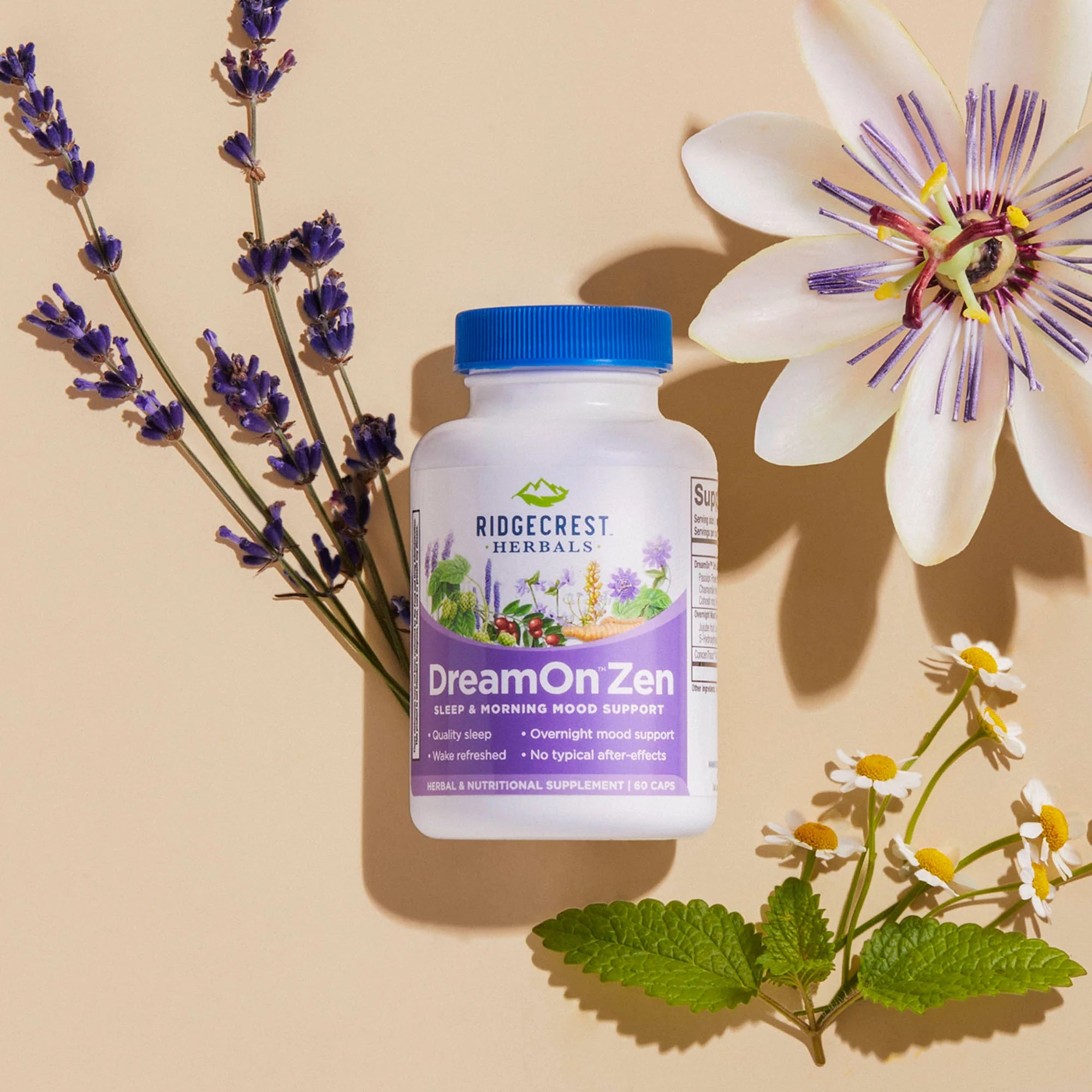 Dream On Zen supplement on a cream backdrop surrounded by lavender, chamomile, and passion flower.