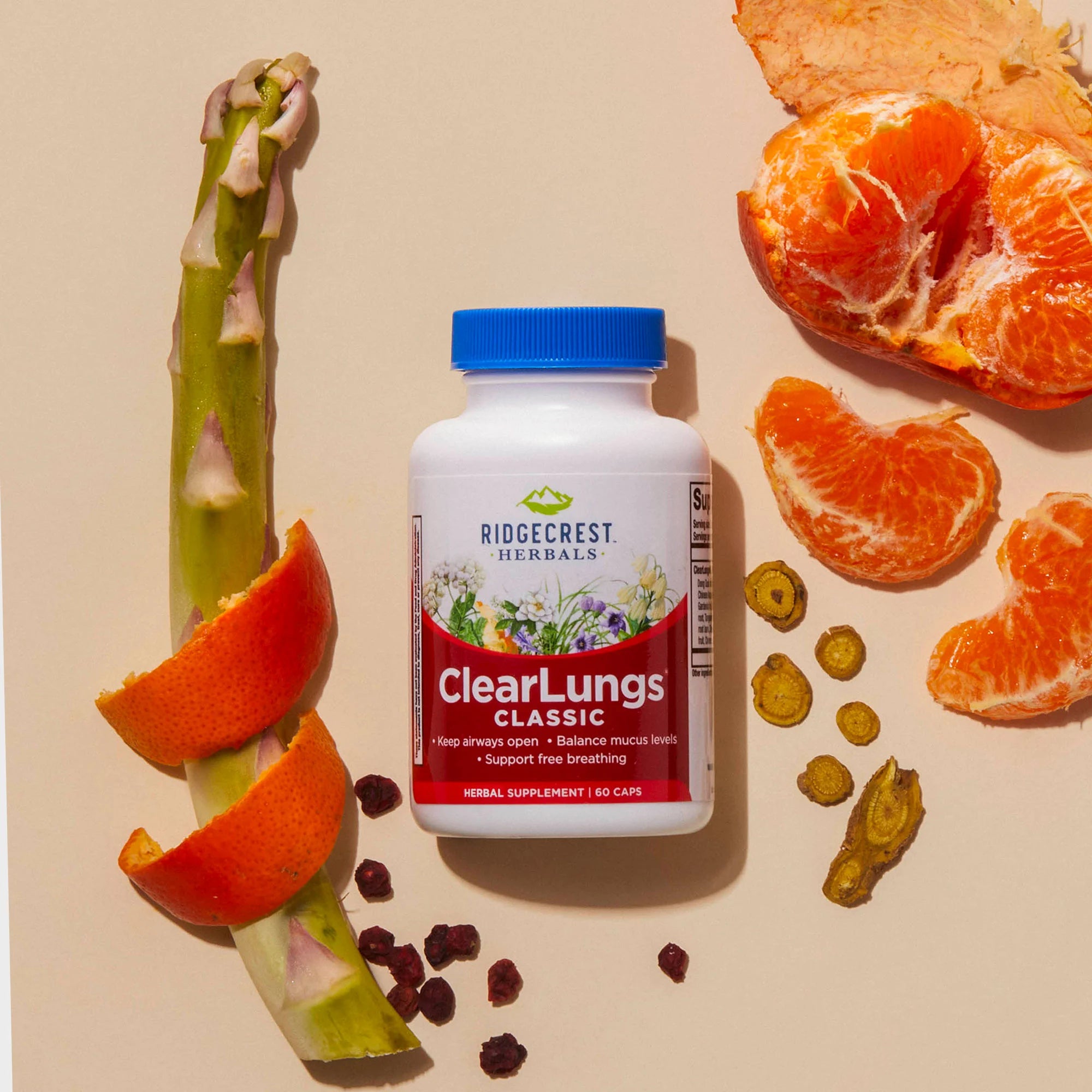 ClearLungs Classic supplement bottle on a cream background with asparagus, tangerine, root slices and berries surrounding it.